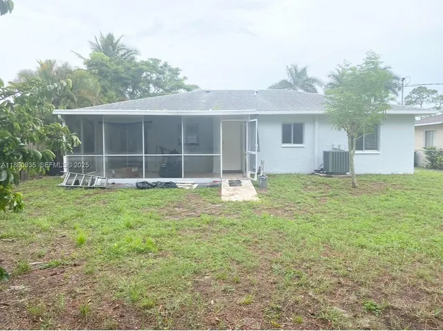 a front view of a house with a garden and yard
