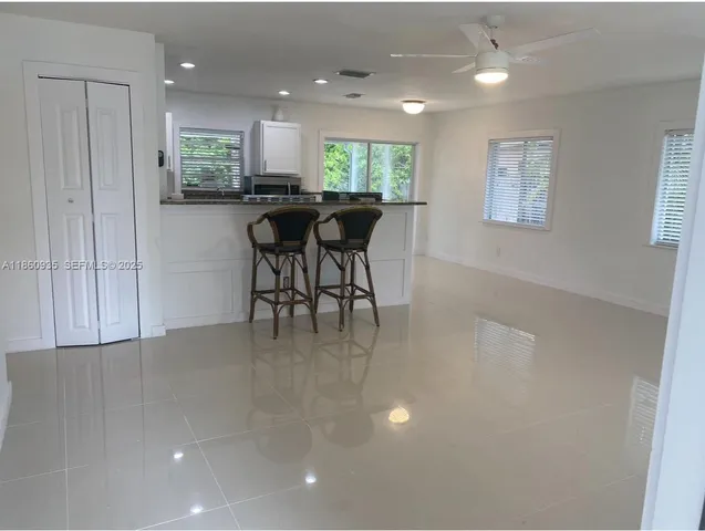 a view of a kitchen and dining area with chandelier