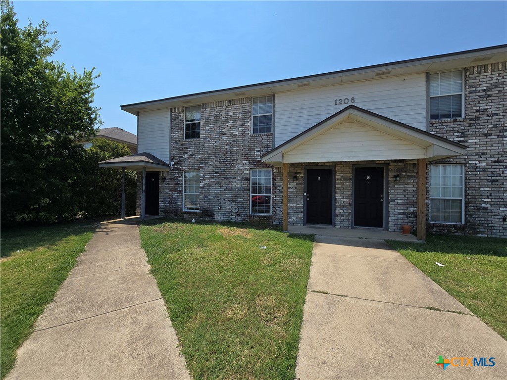 1206 Industrial Boulevard, Unit B Killeen, TX 76549 - Photo 2 of 13 front view of a house with a yard