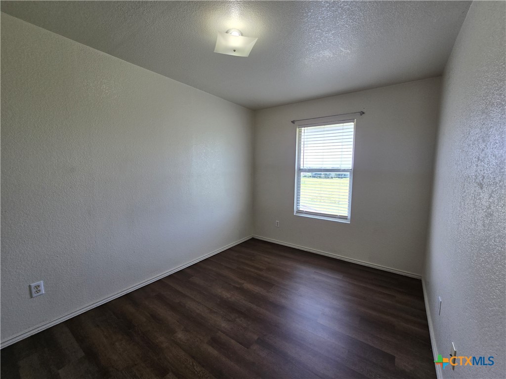 1206 Industrial Boulevard, Unit B Killeen, TX 76549 - Photo 3 of 13 an empty room with wooden floor and windows