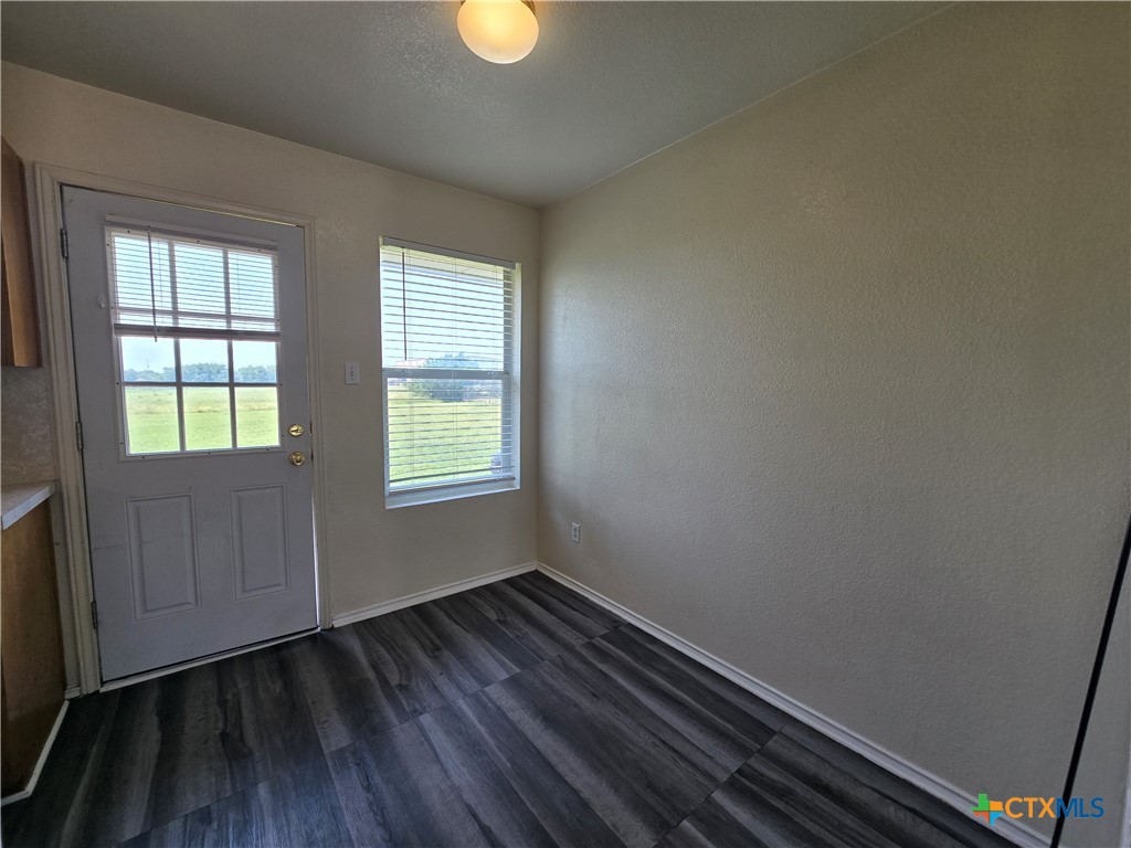 1206 Industrial Boulevard, Unit B Killeen, TX 76549 - Photo 9 of 13 an empty room with wooden floor and windows