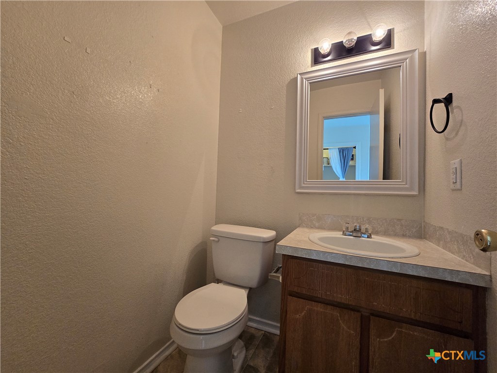 1206 Industrial Boulevard, Unit B Killeen, TX 76549 - Photo 10 of 13 a bathroom with a toilet sink and mirror