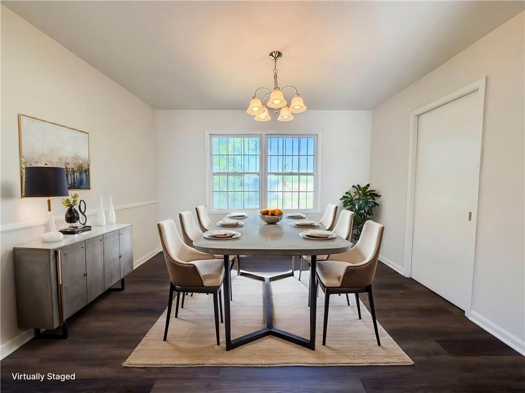 4055 Tecumseh Trail Conley, GA 30288 - Photo 11 of 30 a view of a dining room with furniture window and wooden floor
