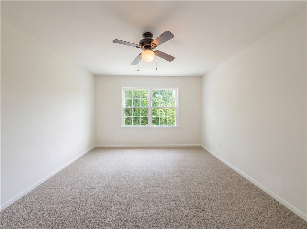 4055 Tecumseh Trail Conley, GA 30288 - Photo 15 of 30 an empty room with a window and a fan