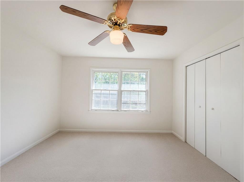4055 Tecumseh Trail Conley, GA 30288 - Photo 16 of 30 an empty room with a window and a fan