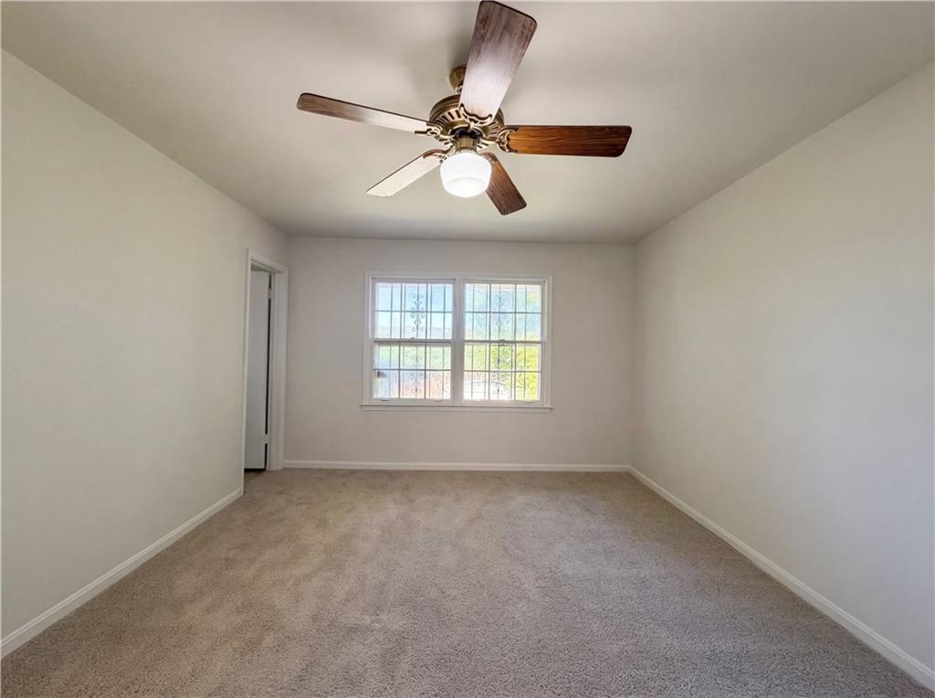 4055 Tecumseh Trail Conley, GA 30288 - Photo 17 of 30 an empty room with a window and a fan