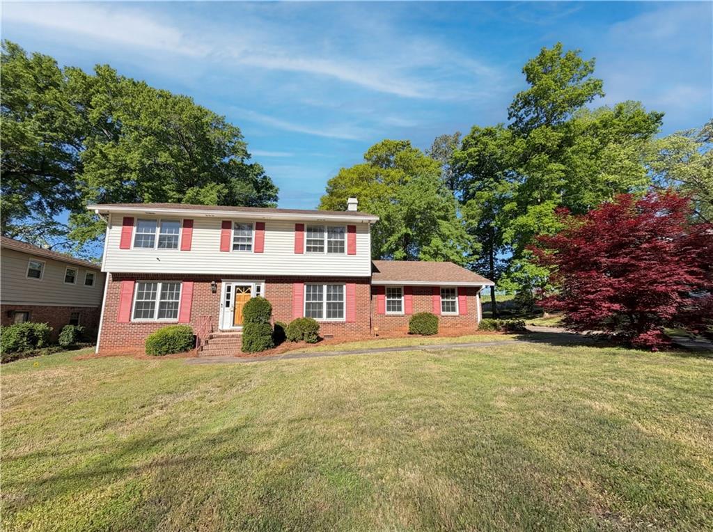 4055 Tecumseh Trail Conley, GA 30288 - Photo 2 of 30 a view of a house with a big yard and large trees