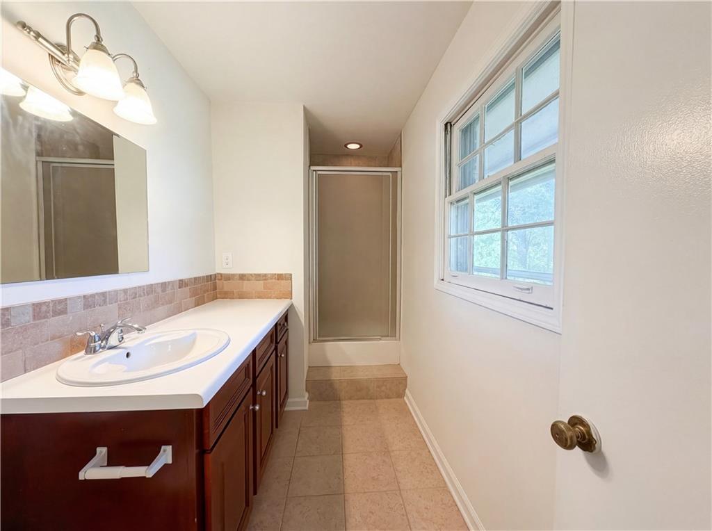 4055 Tecumseh Trail Conley, GA 30288 - Photo 23 of 30 a bathroom with a sink vanity and a mirror
