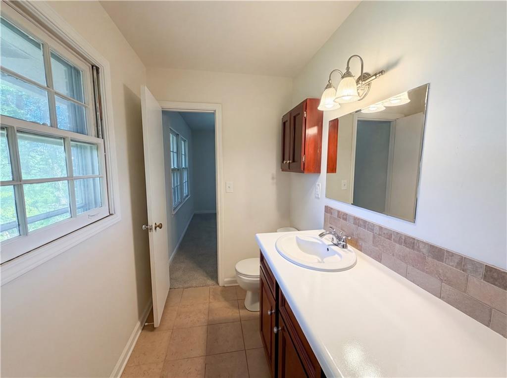 4055 Tecumseh Trail Conley, GA 30288 - Photo 24 of 30 a bathroom with a sink vanity and a mirror
