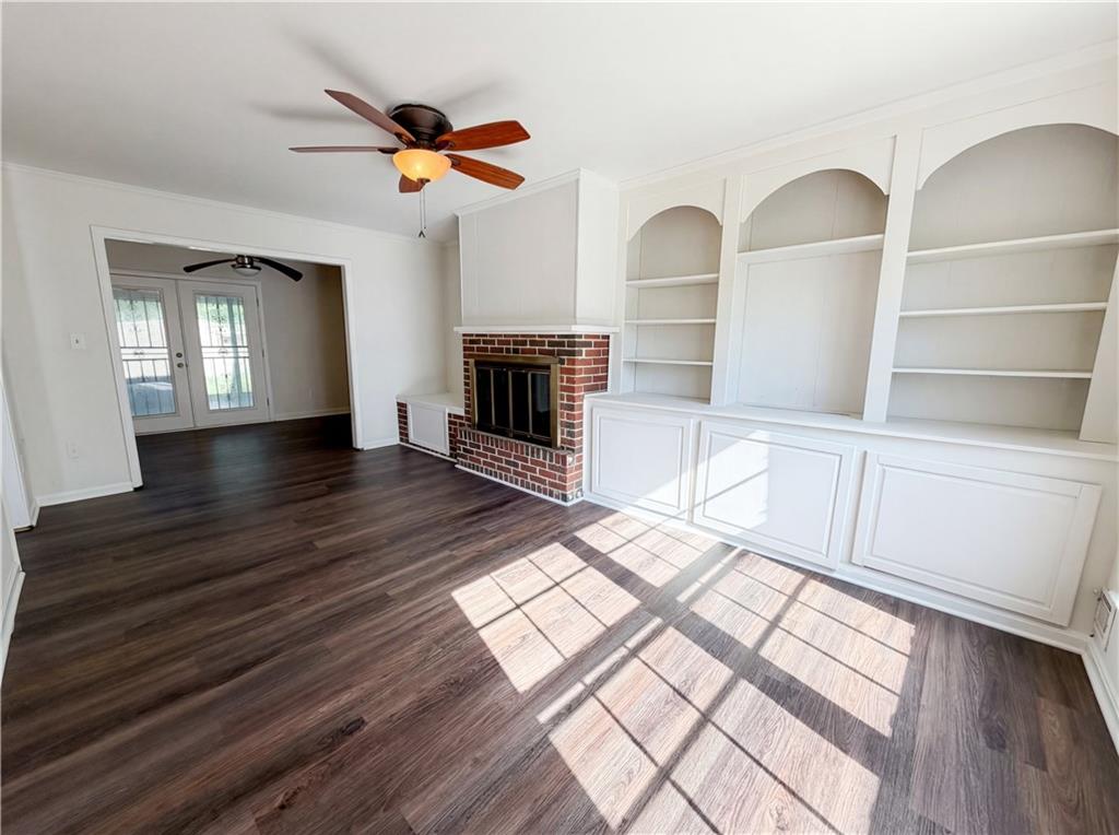 4055 Tecumseh Trail Conley, GA 30288 - Photo 4 of 30 a view of an empty room with wooden floor and a window