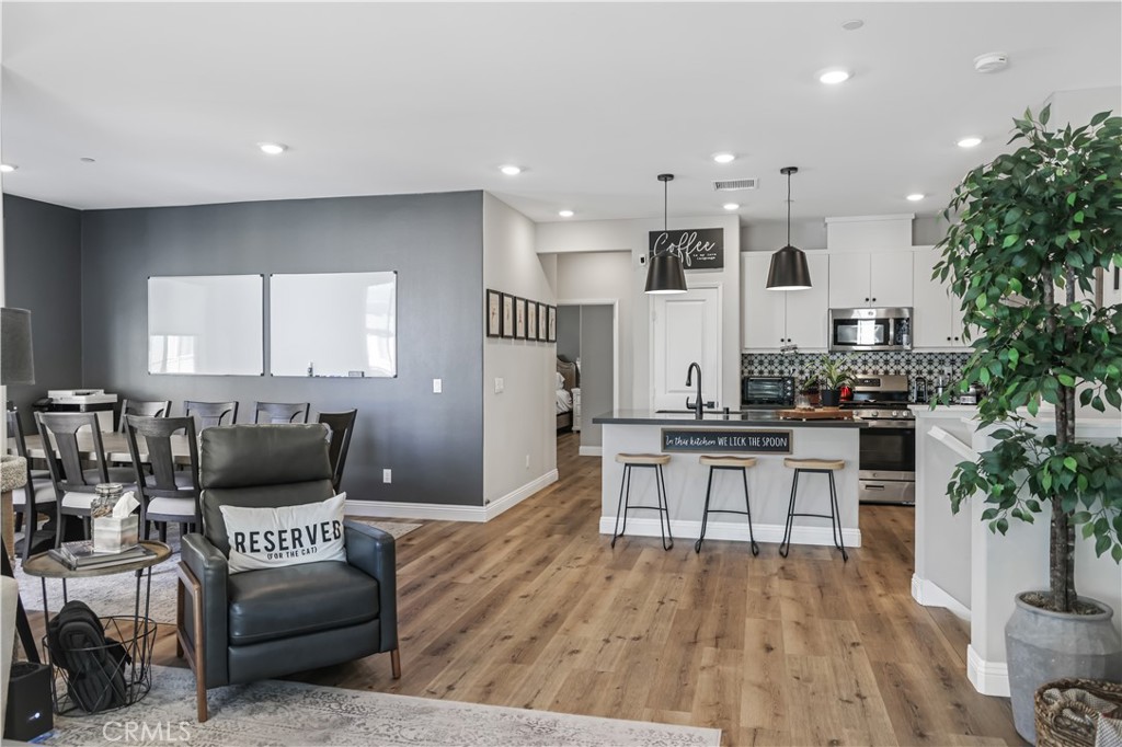 5604 Altamura Way, Unit 11 Fontana, CA 92336 - Photo 11 of 51 a living room with furniture and a wooden floor