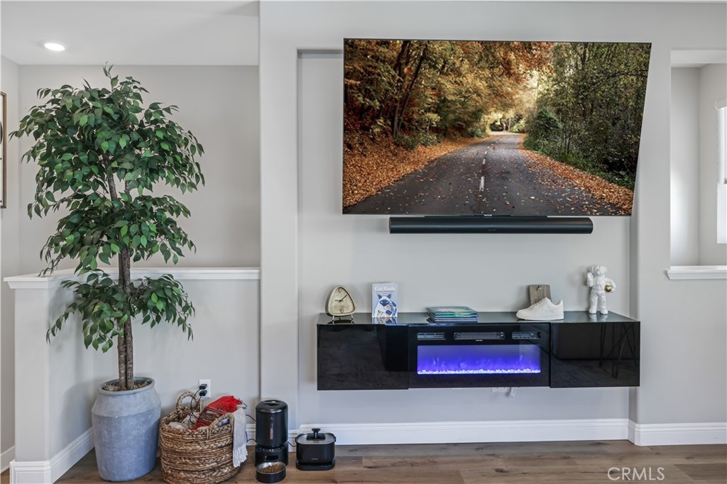 5604 Altamura Way, Unit 11 Fontana, CA 92336 - Photo 12 of 51 a room with lots of potted plants and wooden floor