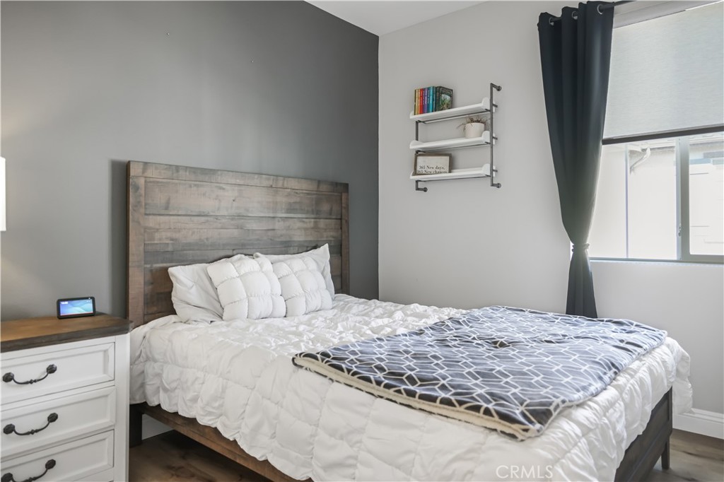 5604 Altamura Way, Unit 11 Fontana, CA 92336 - Photo 18 of 51 a bedroom with a bed and a window