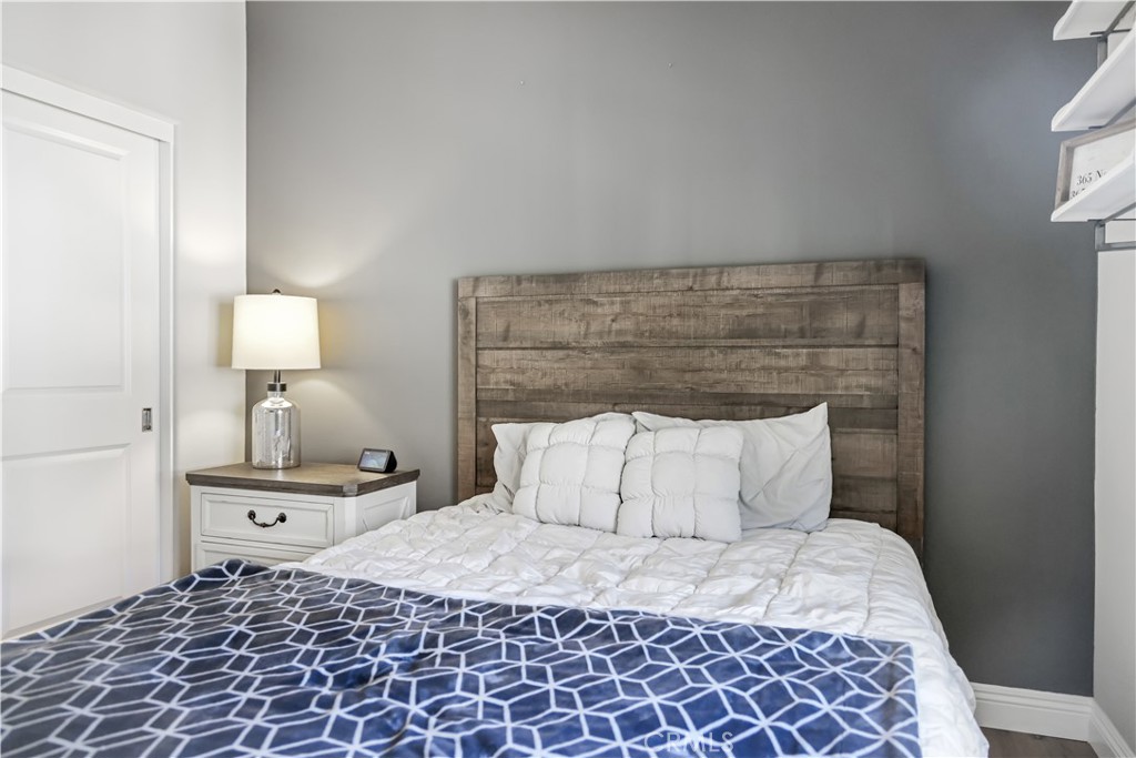 5604 Altamura Way, Unit 11 Fontana, CA 92336 - Photo 19 of 51 a bedroom with a bed and a lamp