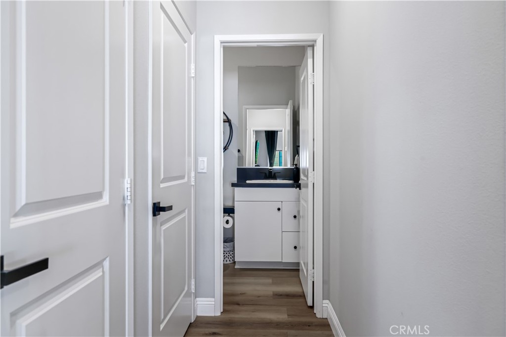 5604 Altamura Way, Unit 11 Fontana, CA 92336 - Photo 21 of 51 a view of a hallway with wooden floor and a bathroom
