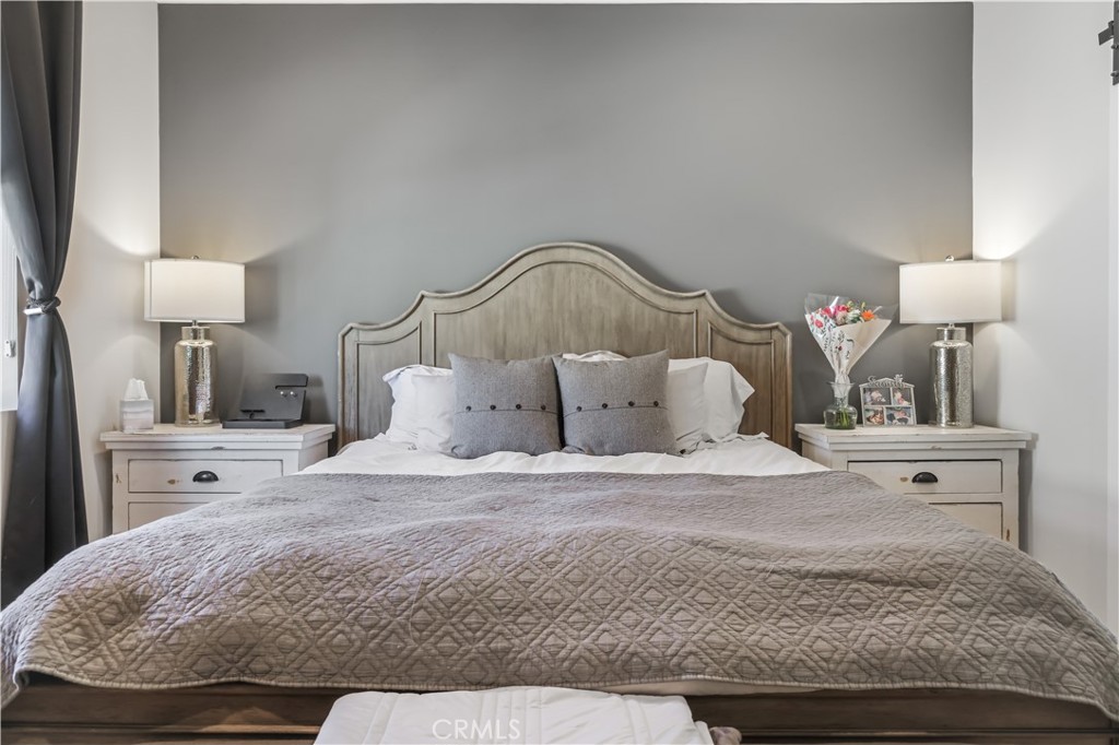 5604 Altamura Way, Unit 11 Fontana, CA 92336 - Photo 23 of 51 a bedroom with a bed and a night stand