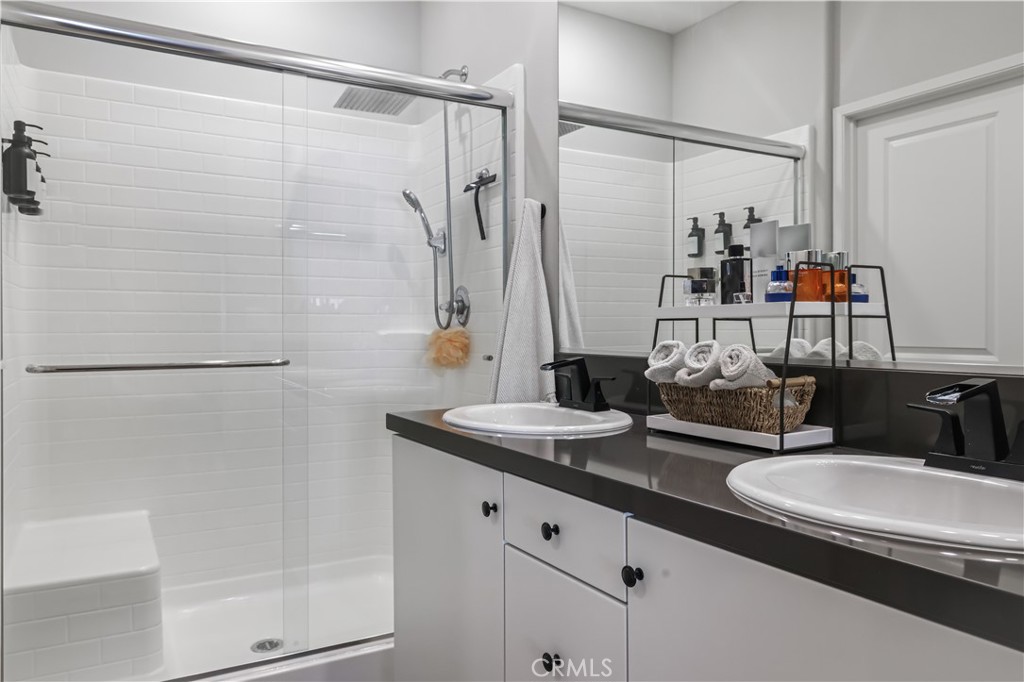 5604 Altamura Way, Unit 11 Fontana, CA 92336 - Photo 27 of 51 a bathroom with double sink and a mirror