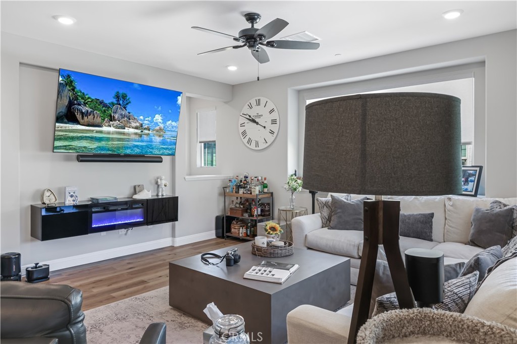 5604 Altamura Way, Unit 11 Fontana, CA 92336 - Photo 4 of 51 a living room with furniture and a flat screen tv