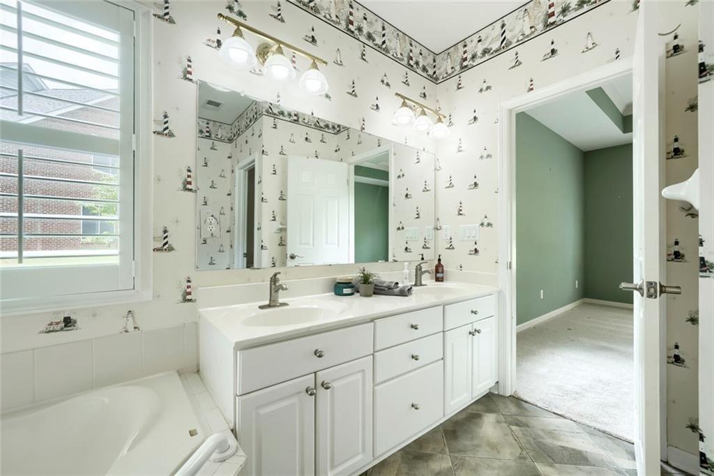 3413 Doe's Court Villa Rica, GA 30180 - Photo 21 of 37 a spacious bathroom with a double vanity sink mirror double and shower