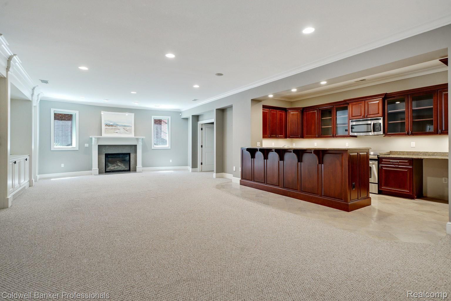 350 Aspen Road Birmingham, MI 48009 - Photo 43 of 60 Huge recreational/entertainment room with fireplace and a 2nd kitchen in the lower level