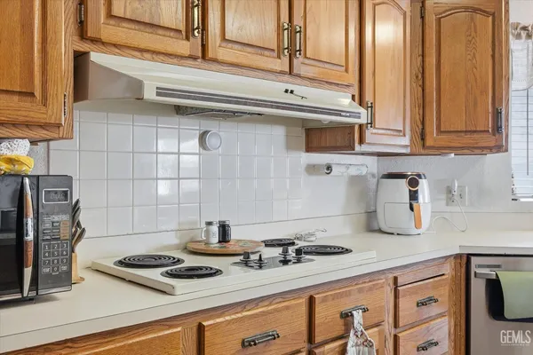 a kitchen with a stove and a refrigerator