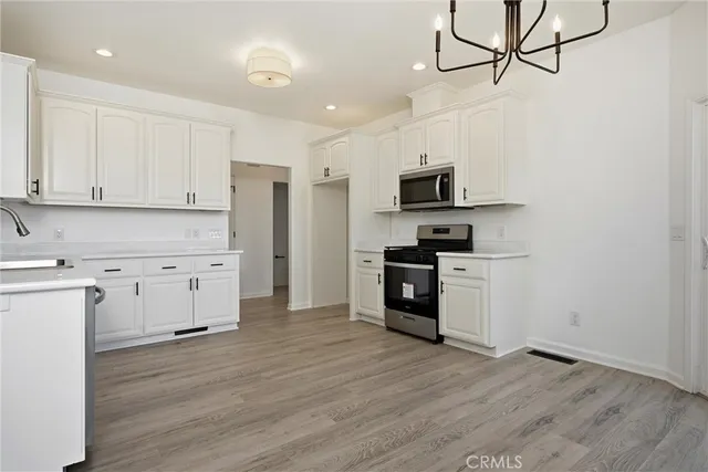 a kitchen with white cabinets and a sink