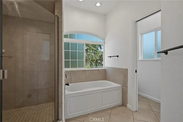 a bathroom with a bathtub and shower