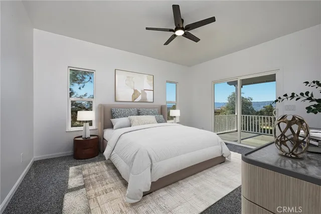 a view of empty room with wooden floor and ceiling fan