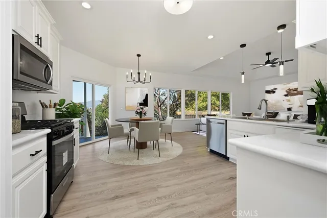 a view of an empty room with wooden floor and closet area