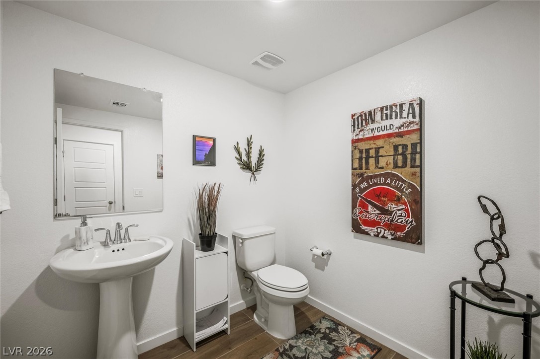 175 Hazel Heights Henderson, NV 89011 - Photo 15 of 55 Half bathroom with baseboards and dark wood-style floors