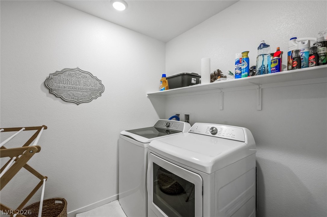 175 Hazel Heights Henderson, NV 89011 - Photo 28 of 55 Laundry room with washing machine and clothes dryer and baseboards
