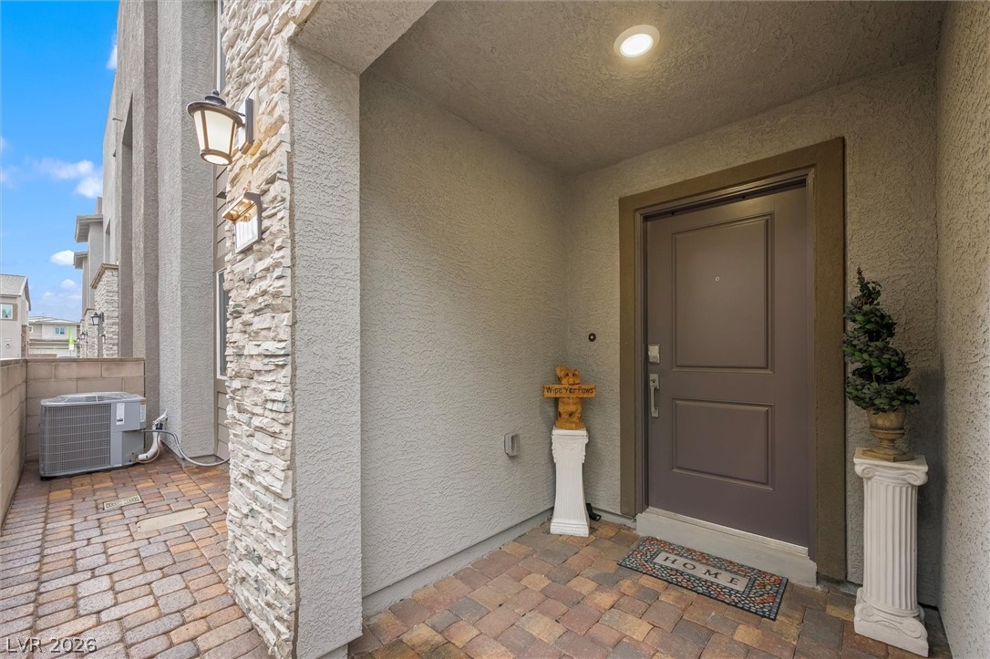 175 Hazel Heights Henderson, NV 89011 - Photo 36 of 55 Doorway to property with stucco siding and stone siding