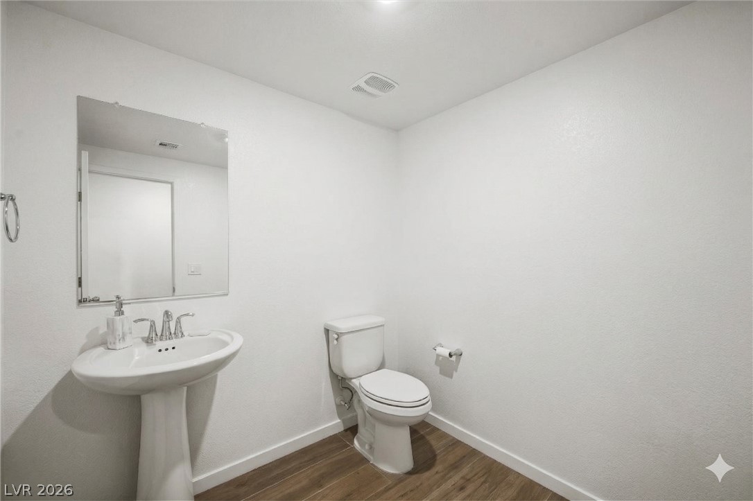 175 Hazel Heights Henderson, NV 89011 - Photo 48 of 55 Bathroom with baseboards and dark wood finished floors