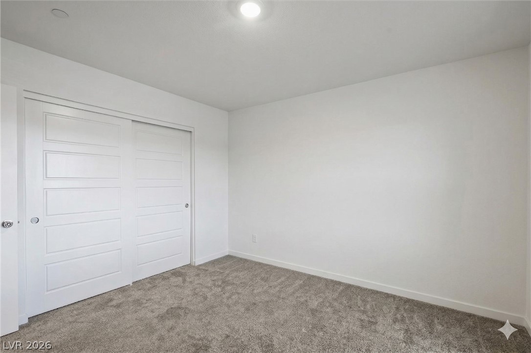 175 Hazel Heights Henderson, NV 89011 - Photo 52 of 55 Unfurnished bedroom featuring carpet and a closet