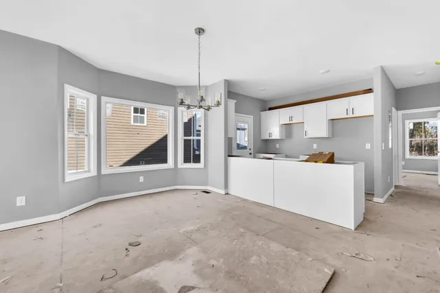 a view of a kitchen with a sink and cabinets
