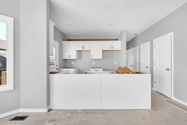 a view of kitchen with refrigerator sink and cabinets