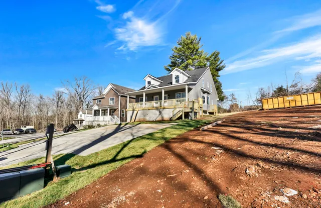a view of a white house with a swimming pool