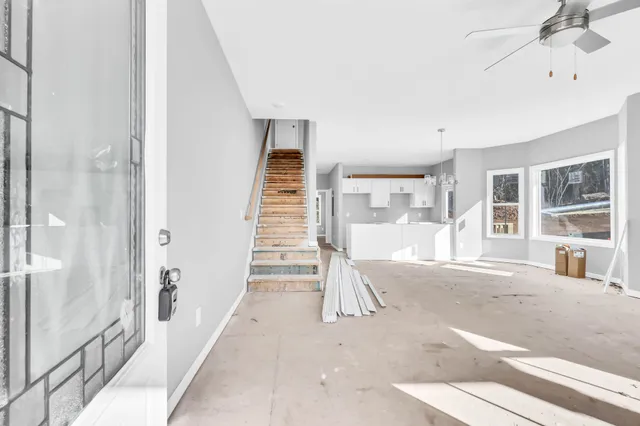 a living room with a fireplace furniture and a rug