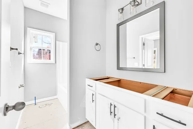 a view of a bathroom with a sink and mirror