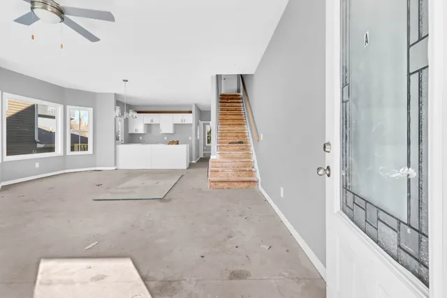 a view of a hallway with wooden floor and entryway