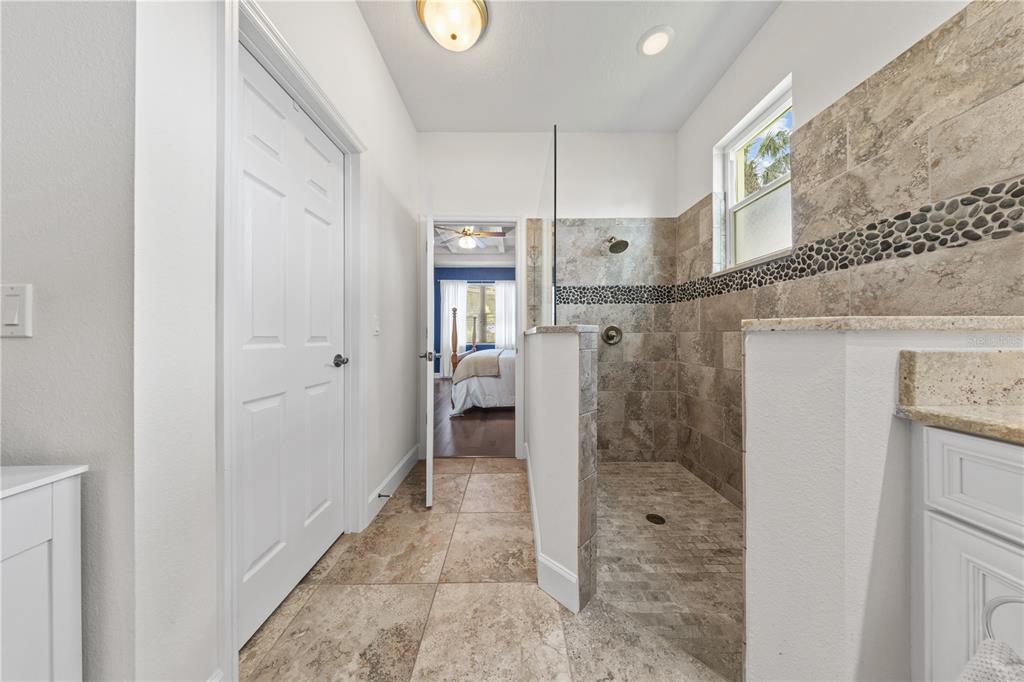 16948 Deer Island Road Tavares, FL 32778 - Photo 21 of 67 a bathroom with a granite countertop shower mirror and a sink