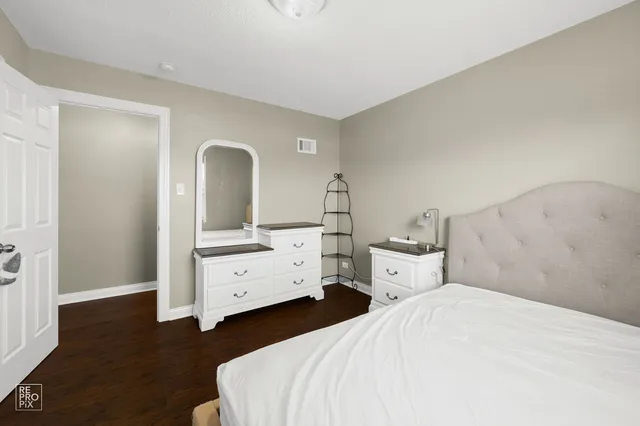 a bedroom with a bed and a dresser