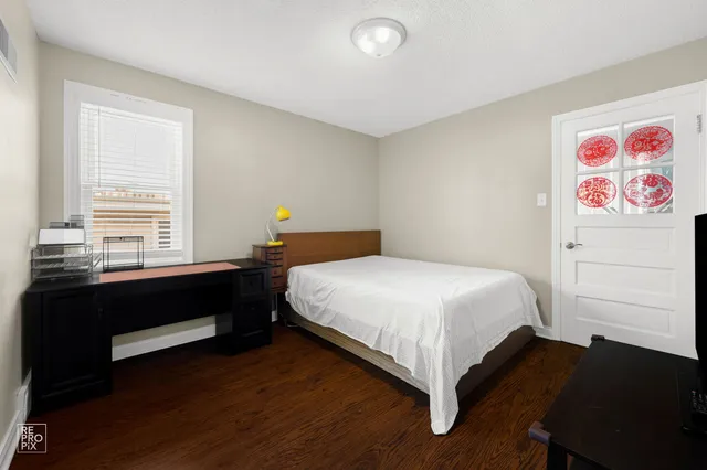 a bed sitting in a bedroom next to a window