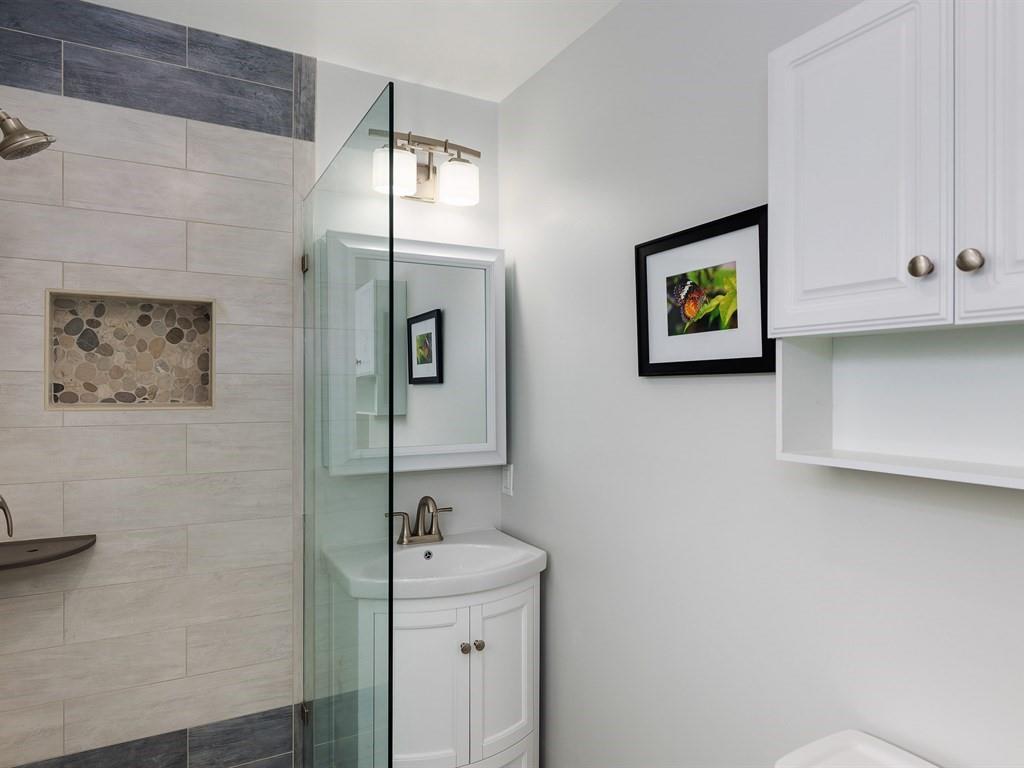 6258 Castillon Drive Newark, CA 94560 - Photo 14 of 20 a bathroom with a sink and a painting on the wall