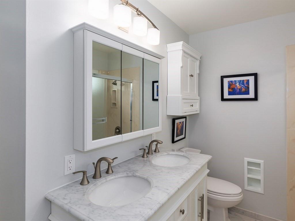 6258 Castillon Drive Newark, CA 94560 - Photo 18 of 20 a bathroom with a toilet a sink and mirror