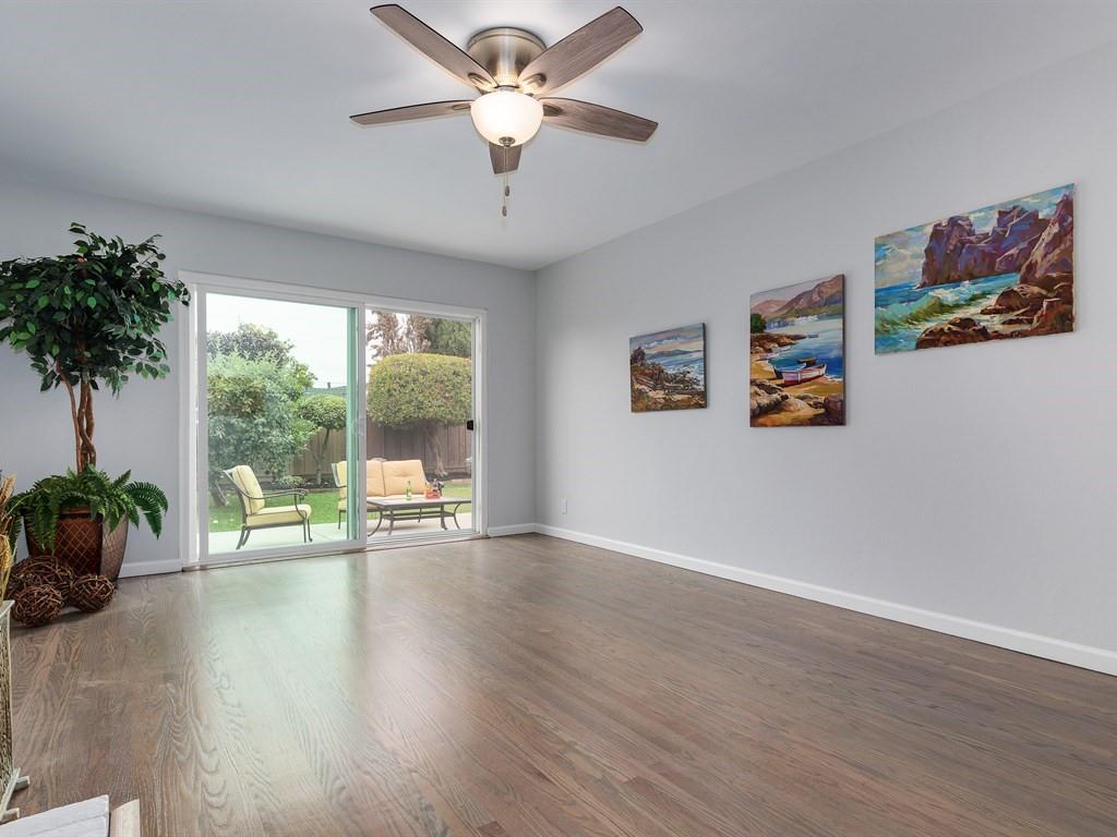 6258 Castillon Drive Newark, CA 94560 - Photo 6 of 20 a view of a livingroom with a large window wooden floor and a chandelier fan