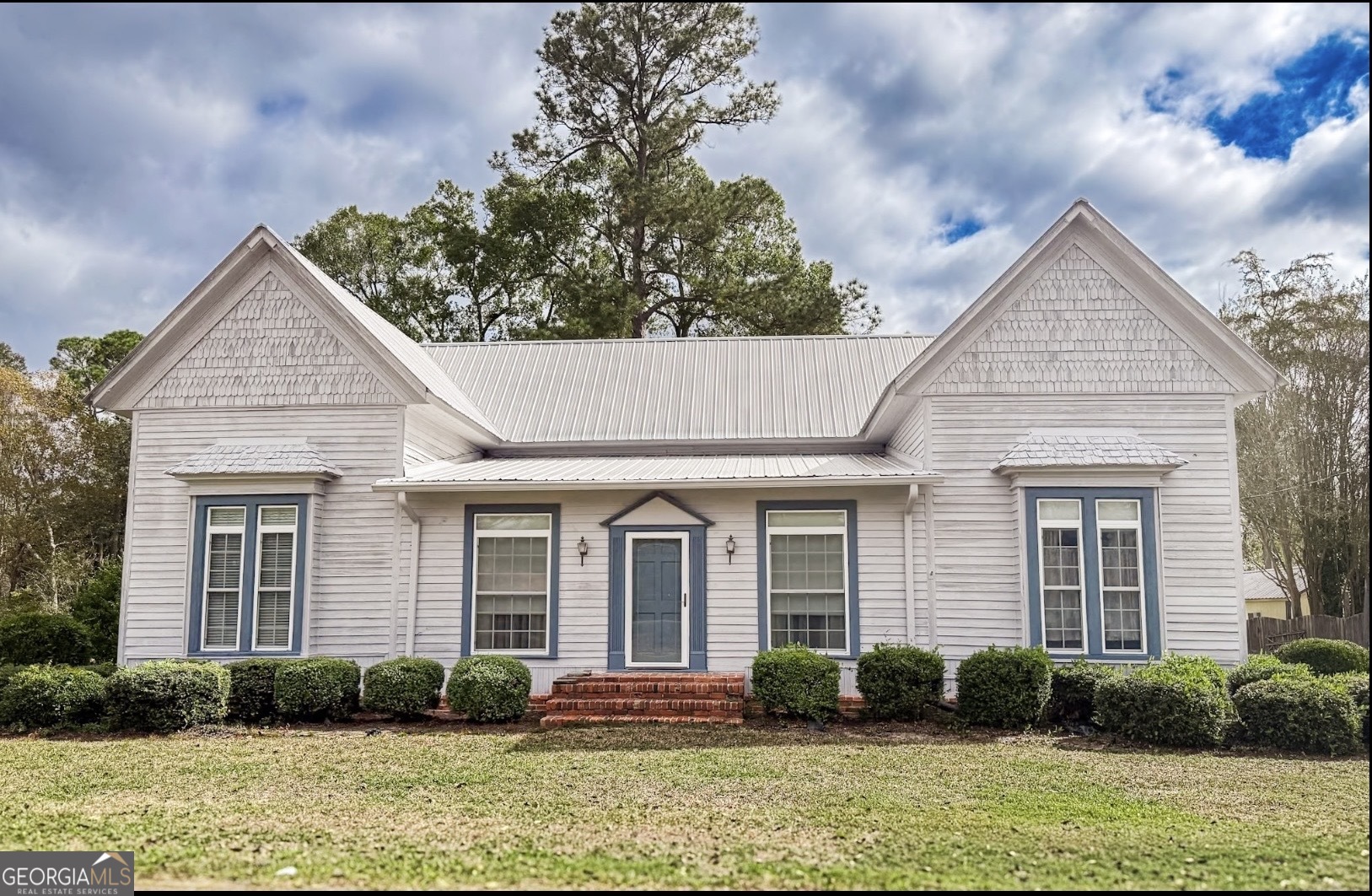 a front view of a house with garden