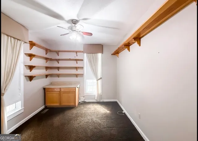 a view of an empty room with a fireplace and a window