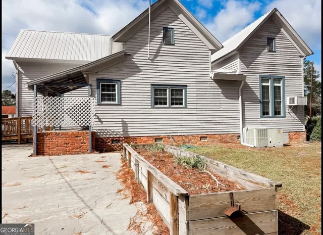 a view of a house with wooden fence