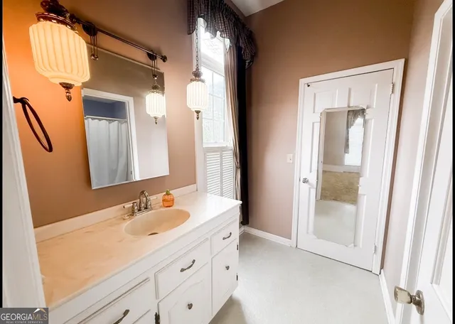 a bathroom with a double vanity sink and a mirror